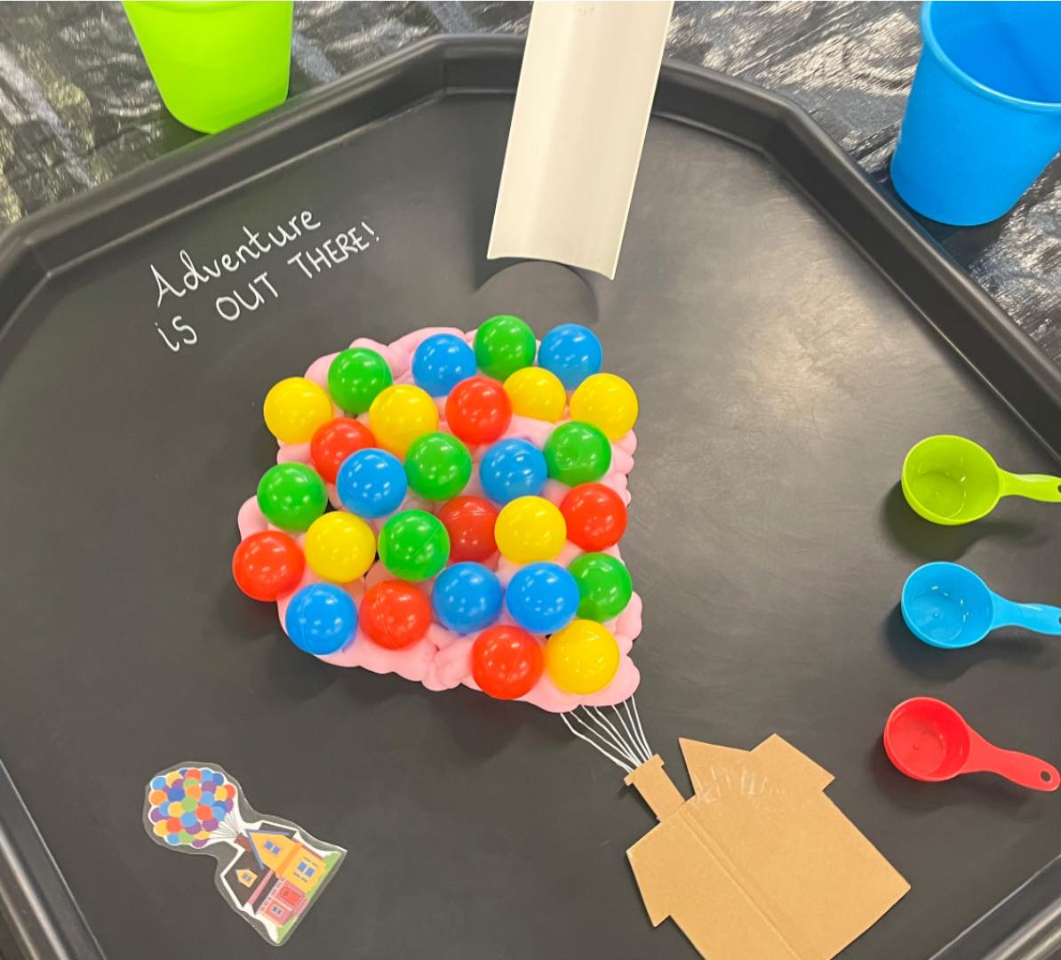 Child painting with bright colours