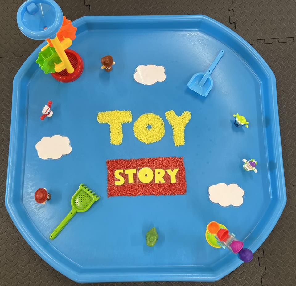 Child painting with bright colours